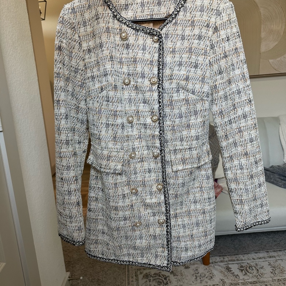 White checkered dress with a tailored silhouette and rounded neckline